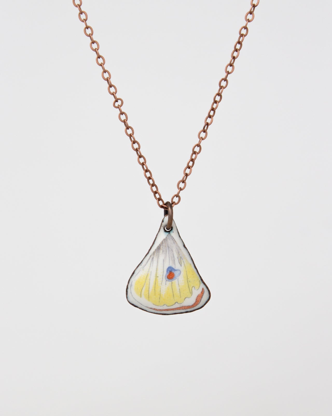 A necklace with a pendant in the shape of a leaf or flower.