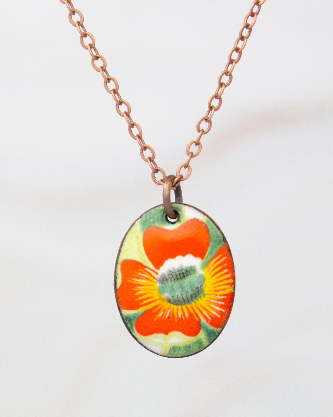 A necklace with a pendant featuring a colorful flower design.