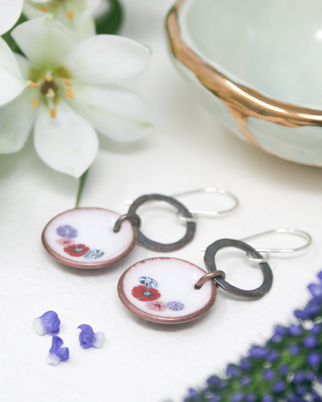 a pair of earrings sitting on top of a table
