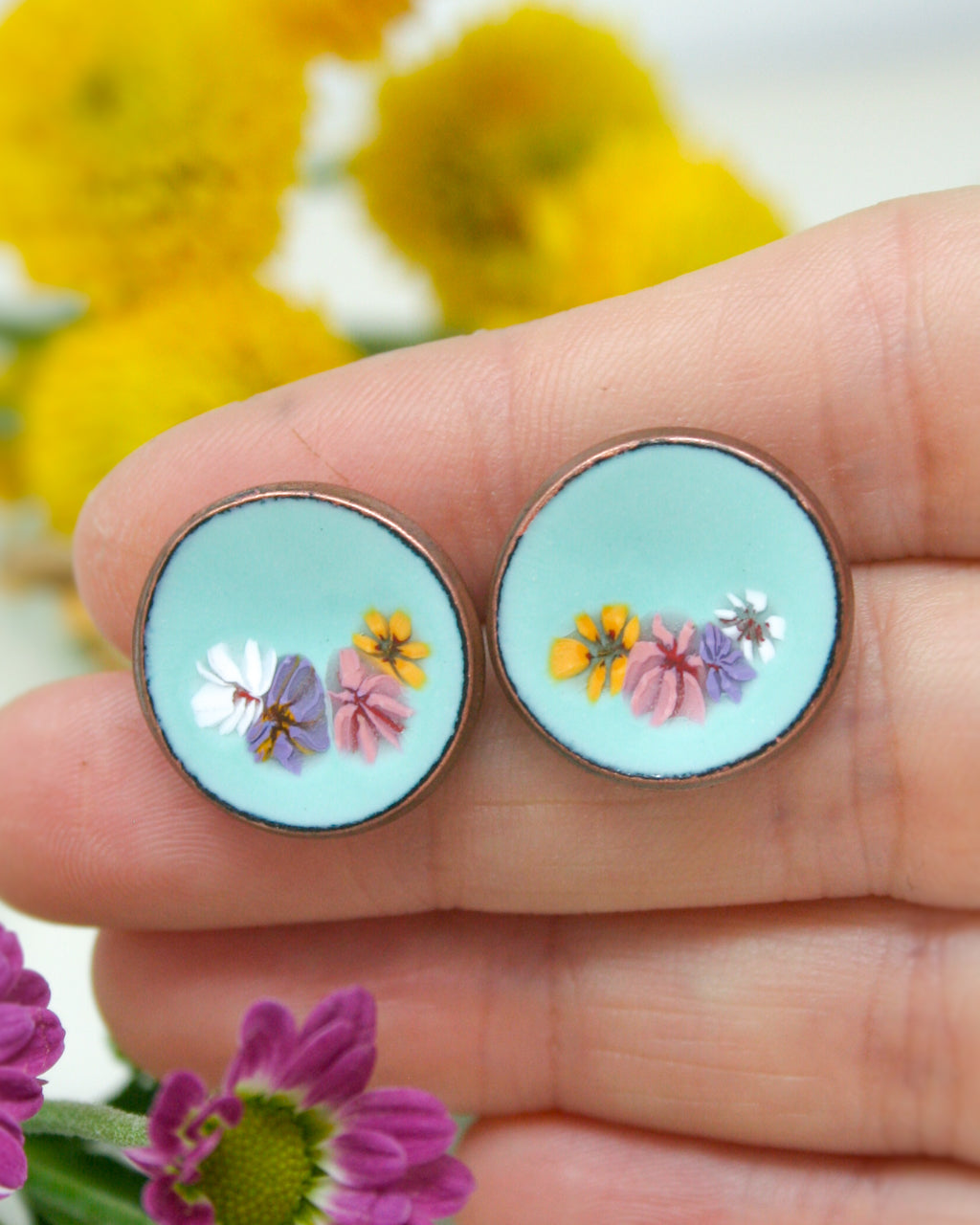 a person holding a pair of earrings in their hand