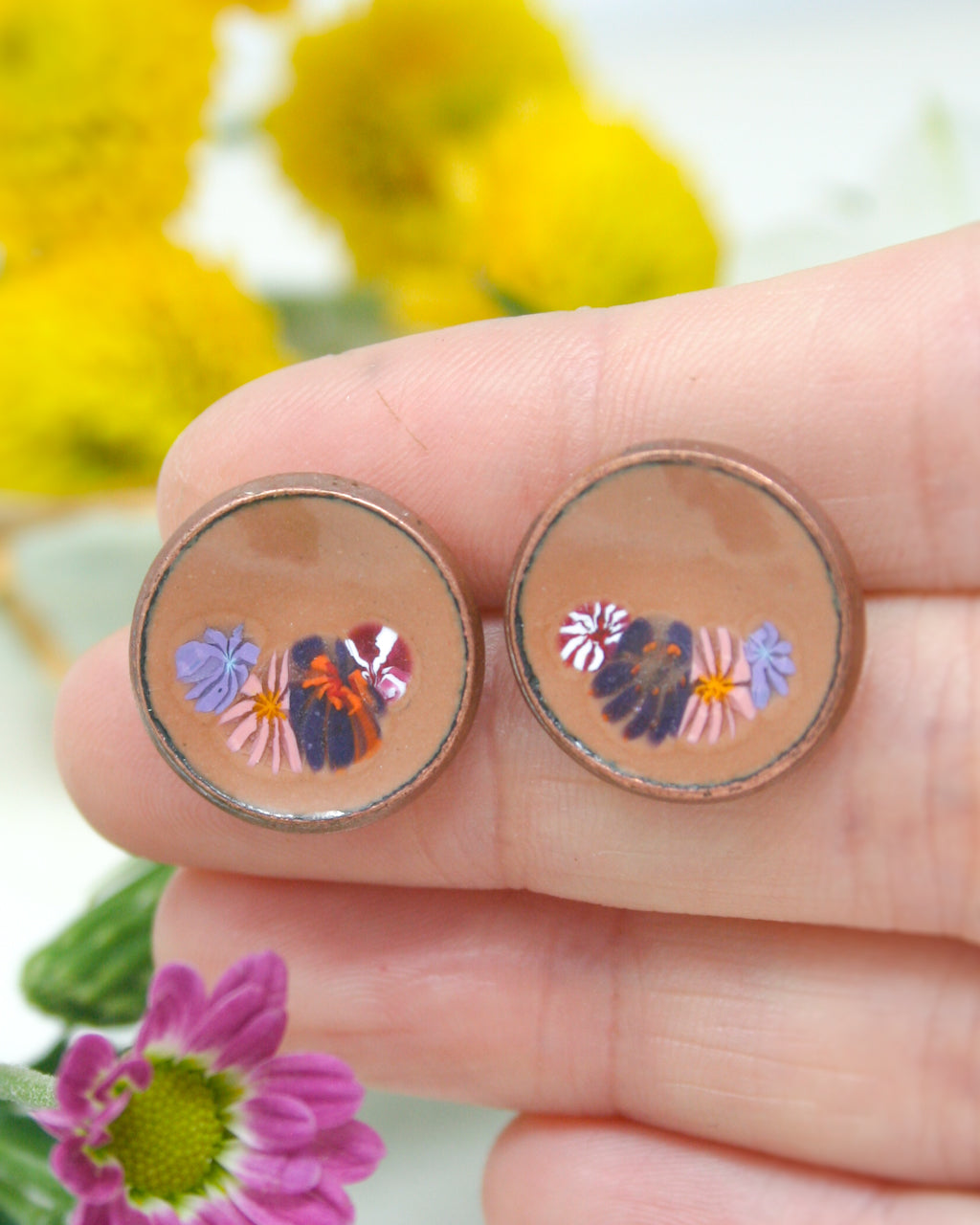 a person holding a pair of earrings in their hand