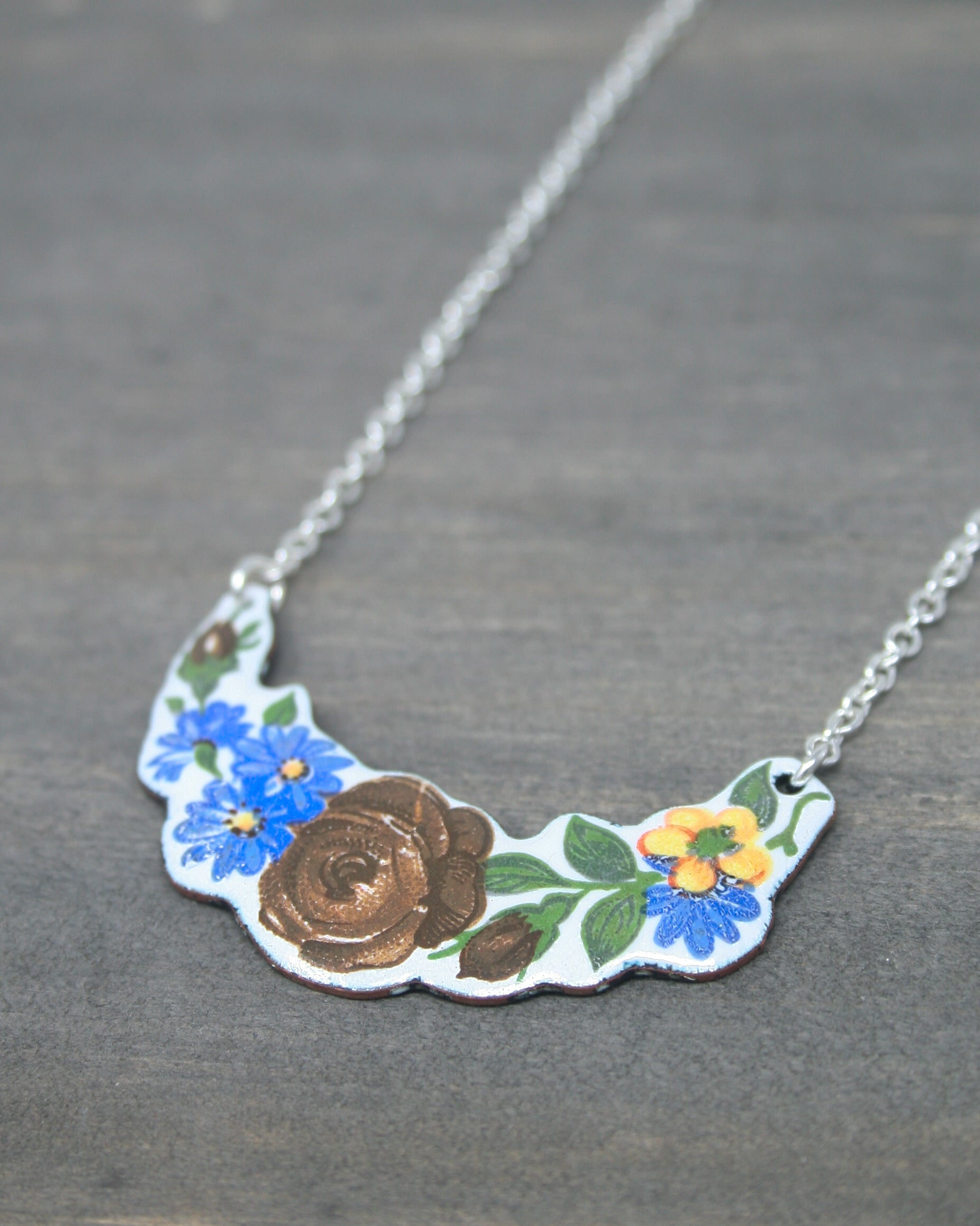 a necklace with a flower design on it