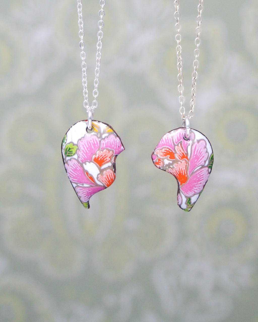 a couple of necklaces that have flowers on them