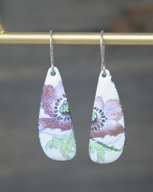 a pair of earrings hanging from a hook