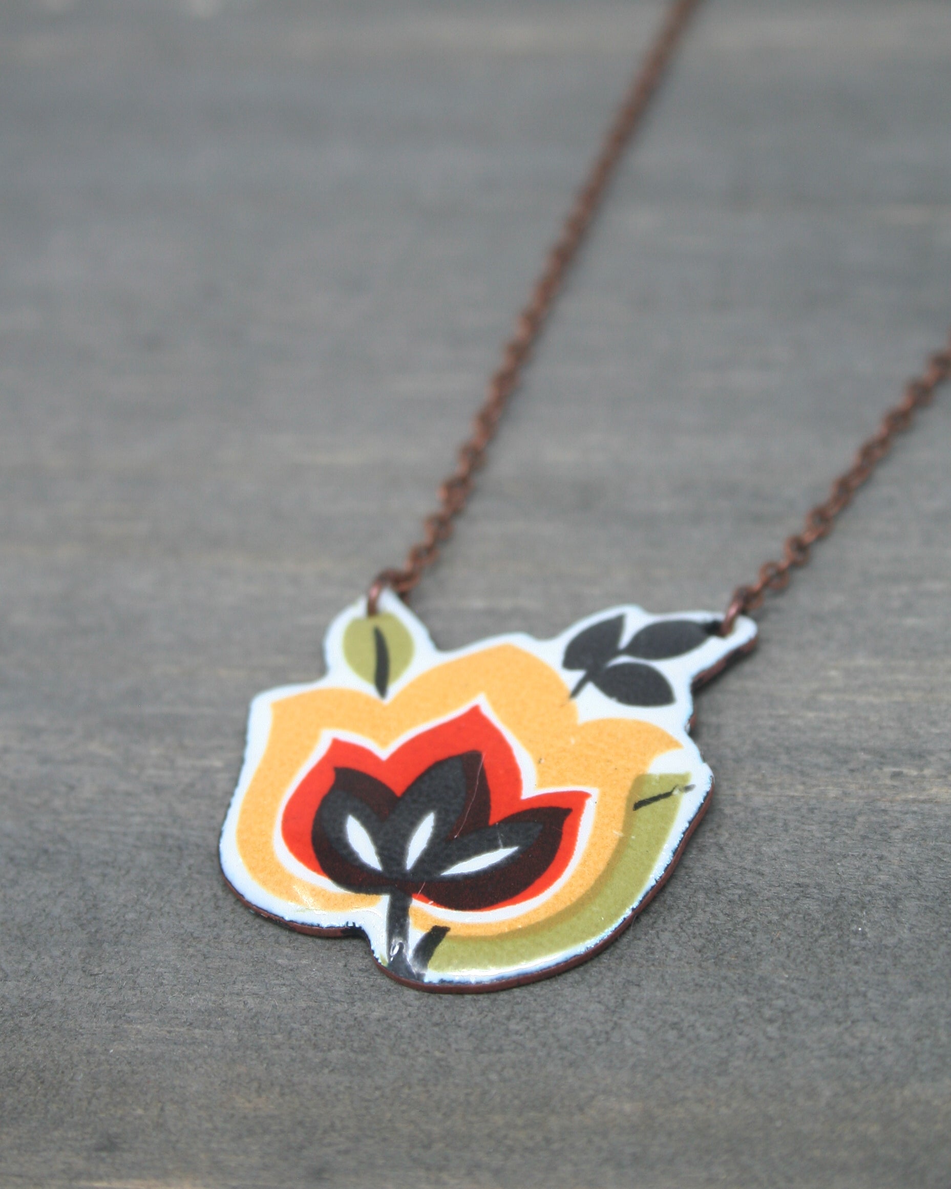 a necklace with a flower painted on it