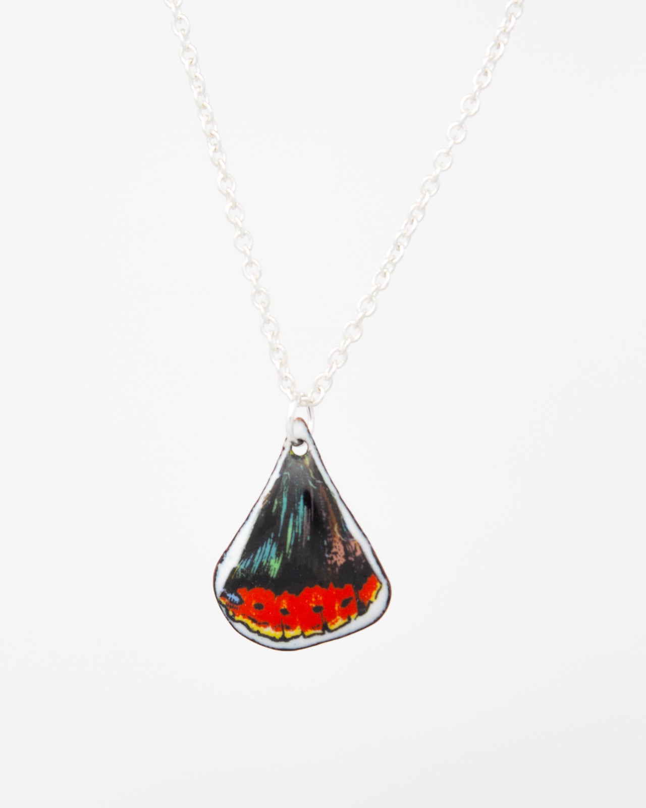 A silver necklace with a pendant featuring a colorful butterfly design.