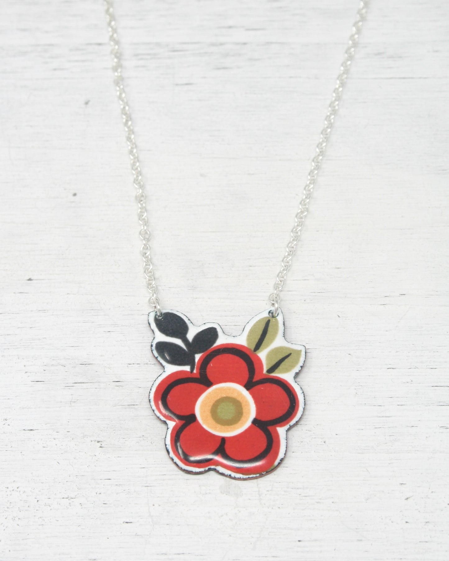 a necklace with a flower painted on it