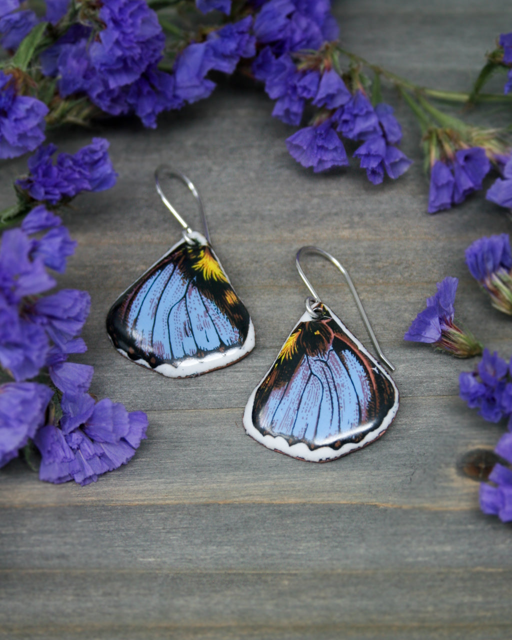 a pair of blue and yellow butterfly earrings