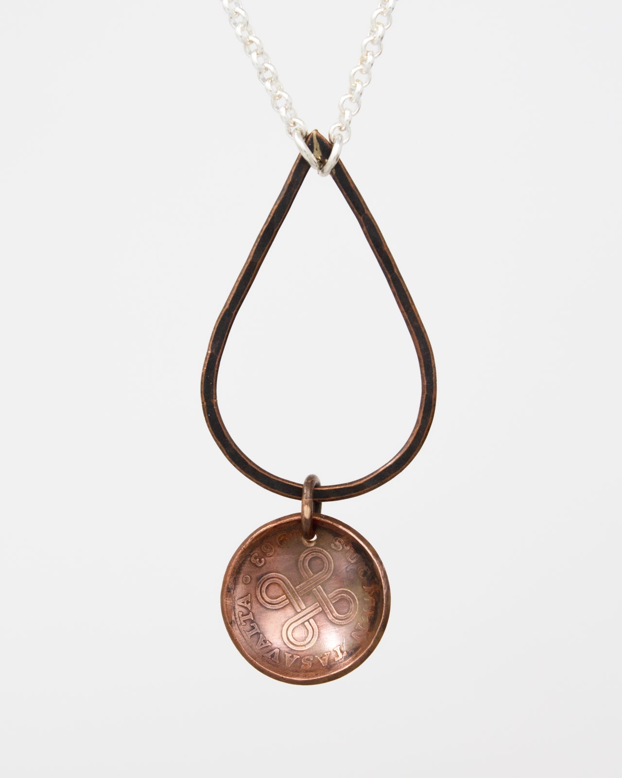A necklace with a circular pendant featuring an intricate design.