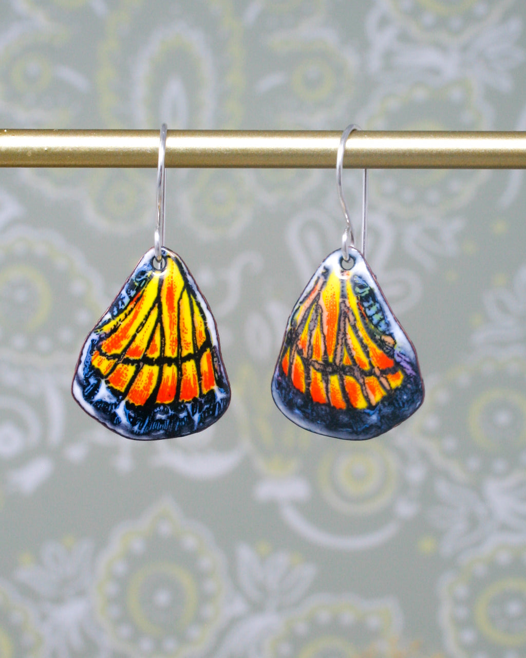 a pair of earrings with a butterfly on them