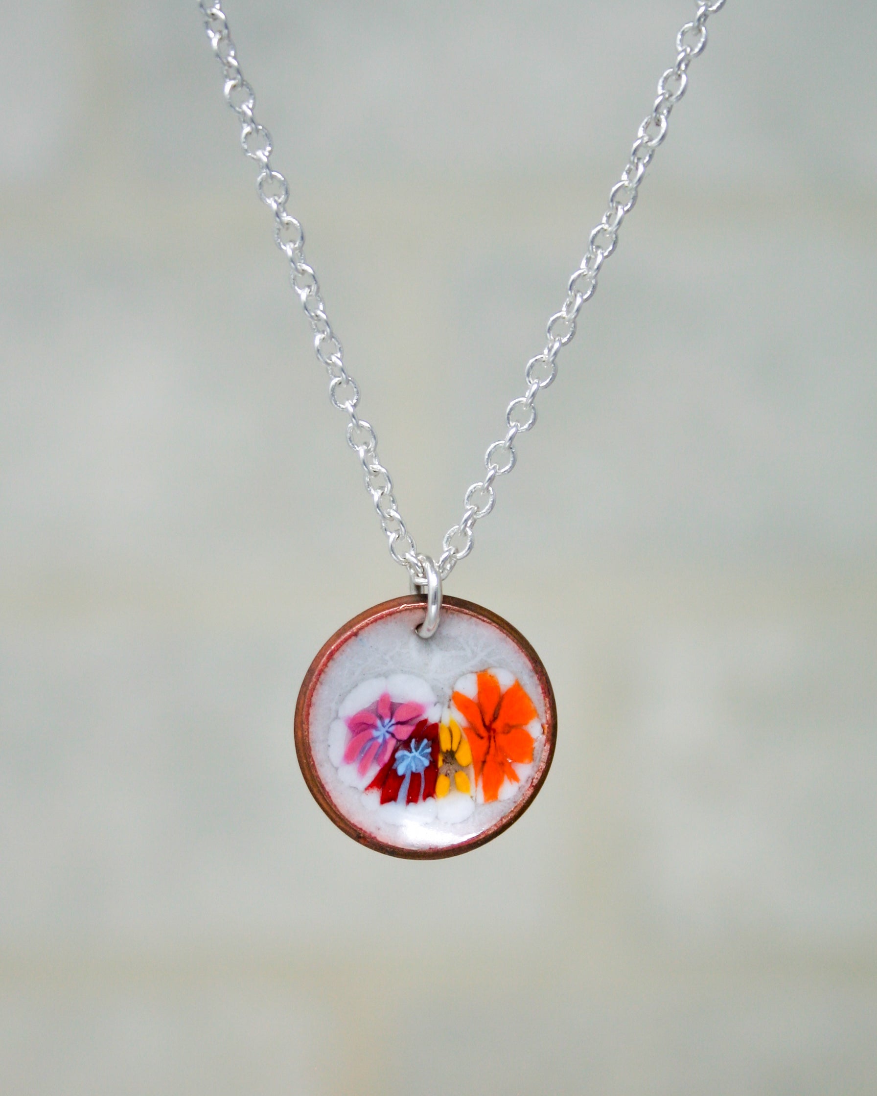 a necklace with a picture of flowers on it