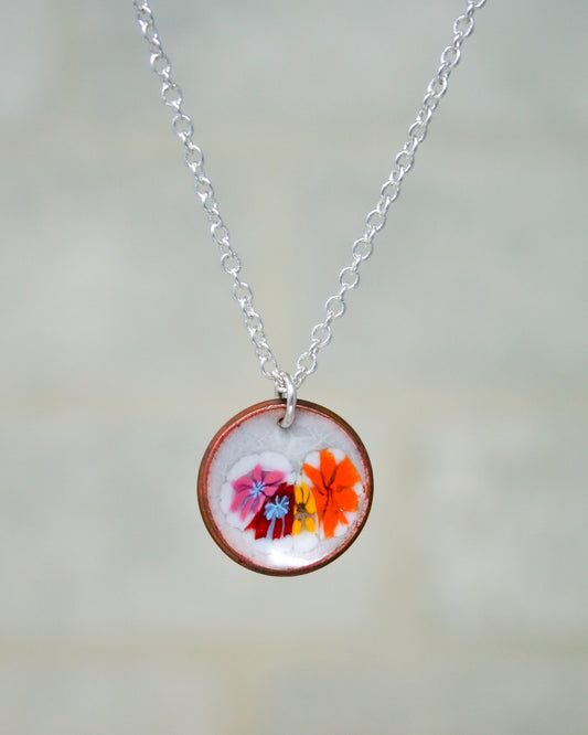 a necklace with a picture of flowers on it