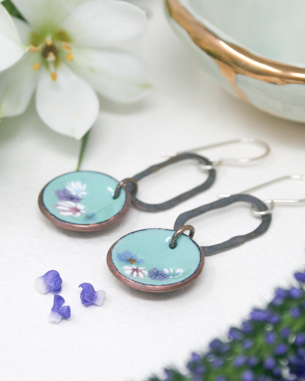 a pair of earrings sitting on top of a table