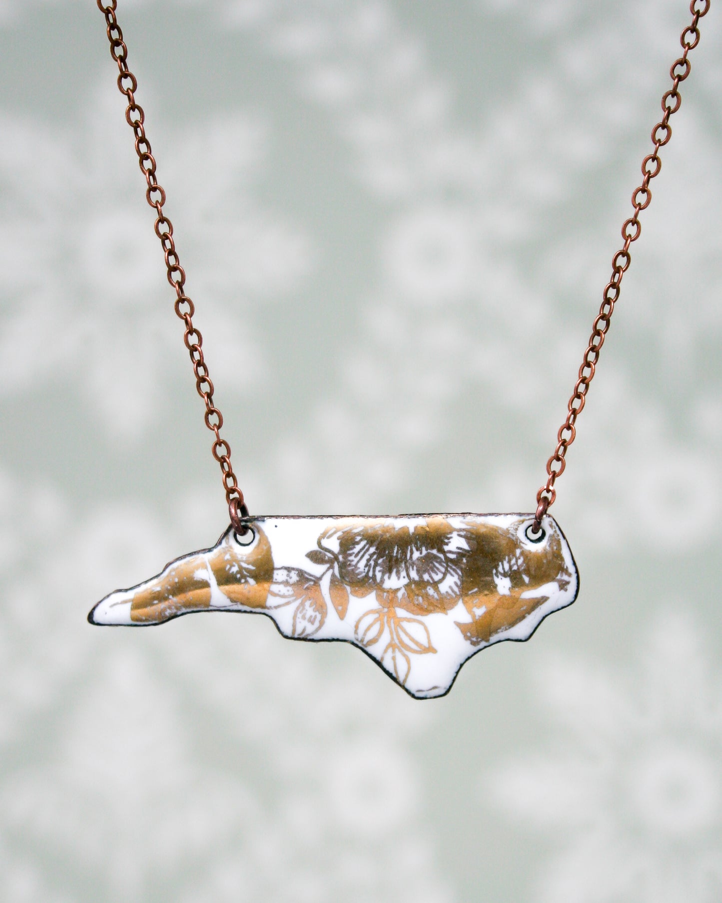 a necklace with a picture of a giraffe on it