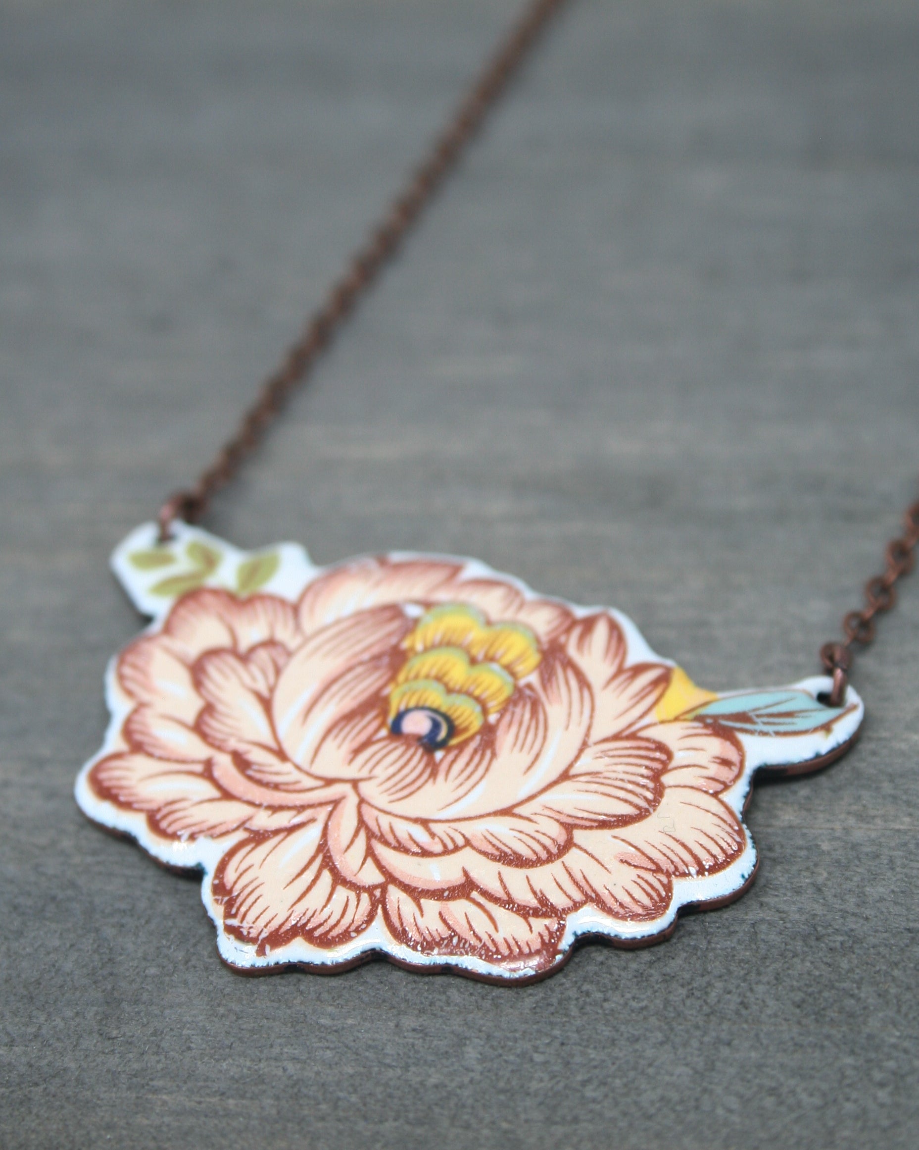 a necklace with a picture of a flower on it