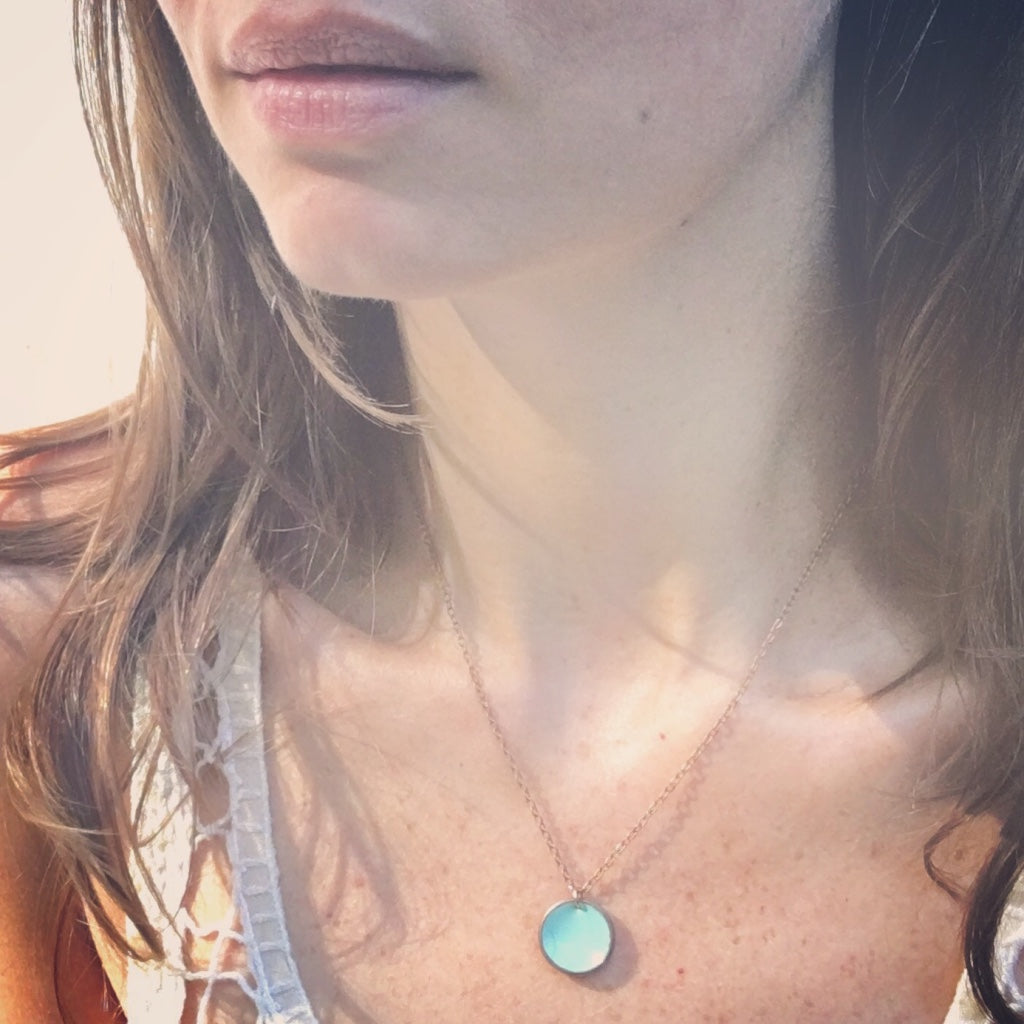 a close up of a person wearing a necklace