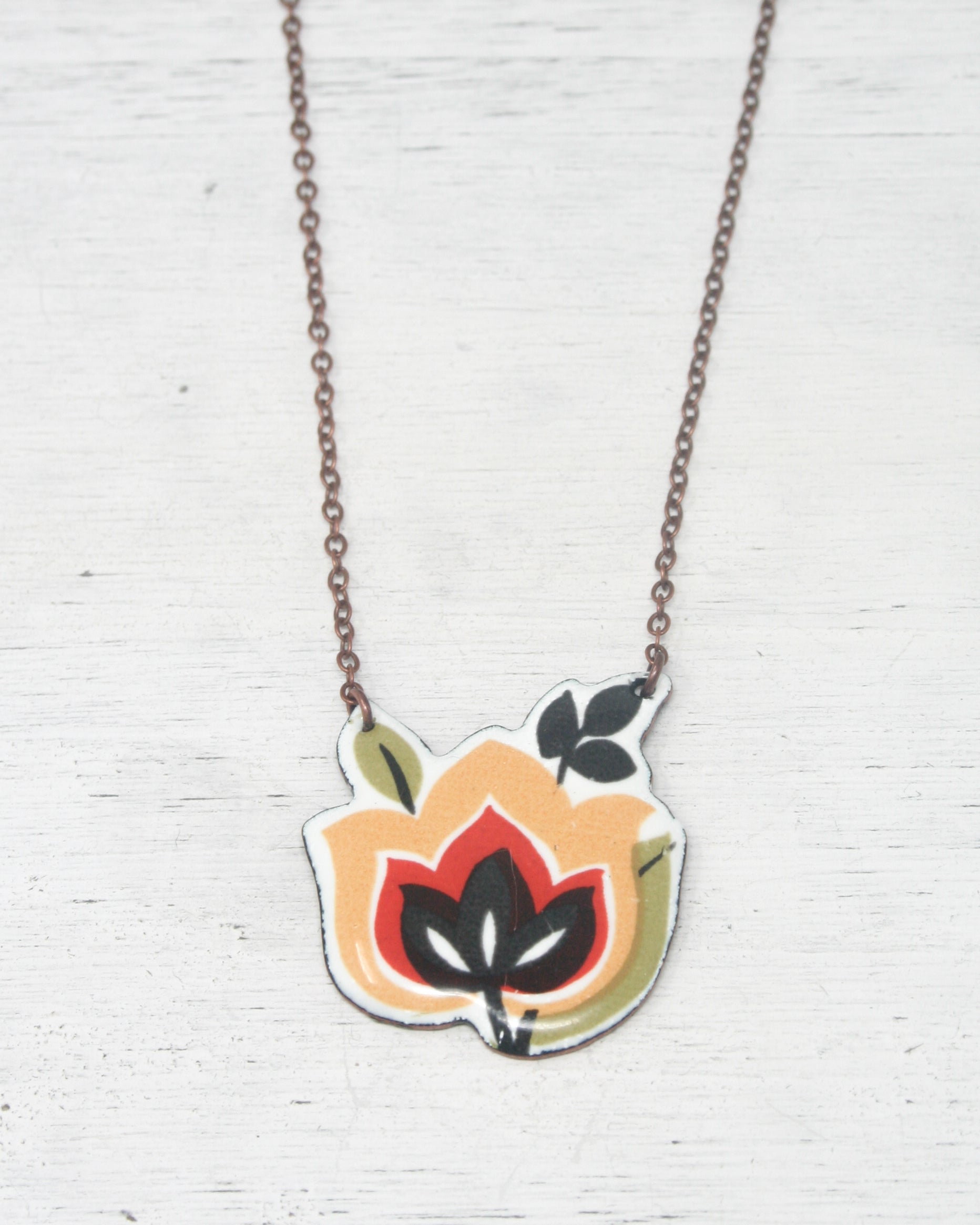 a necklace that has a flower on it