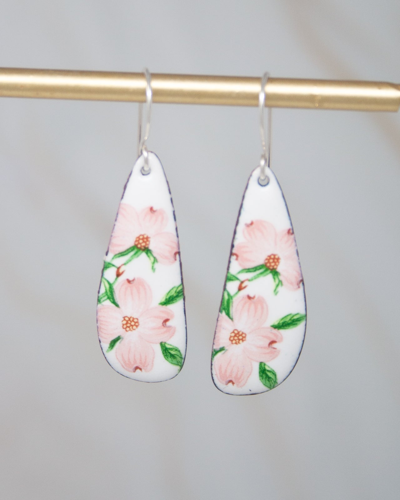 A pair of earrings with a floral design on a white background.