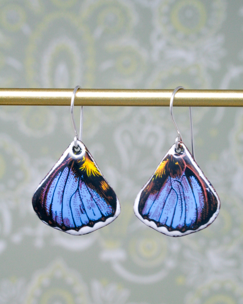 a pair of blue and yellow butterfly earrings