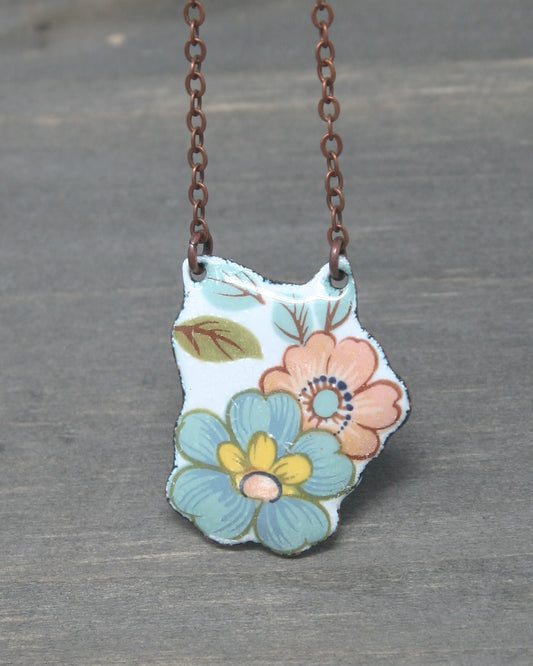 a necklace with a picture of a flower on it