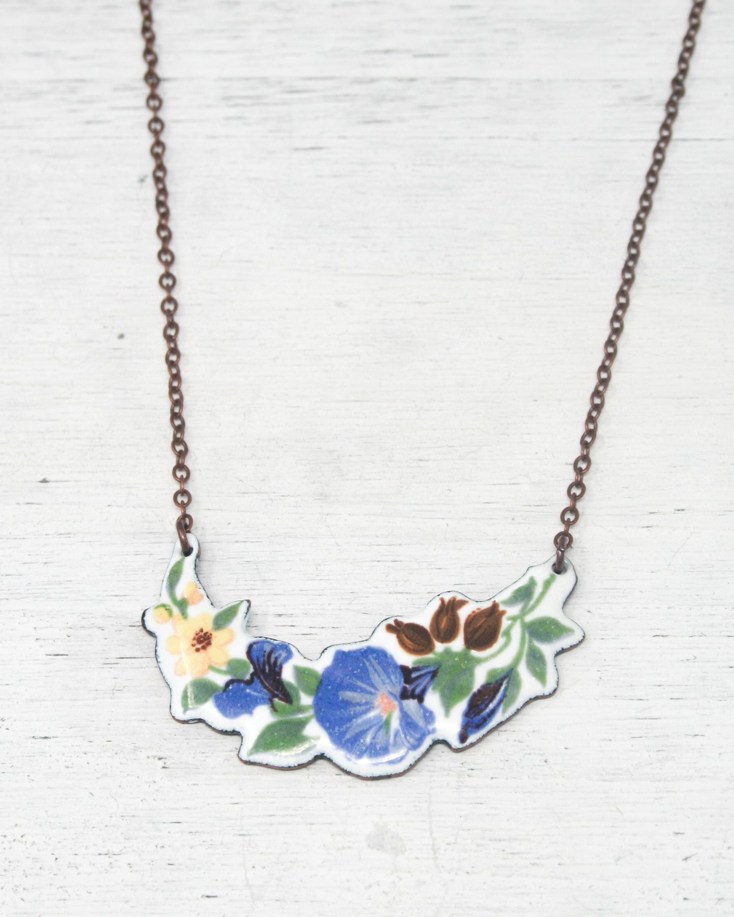 a necklace with a flower design on it