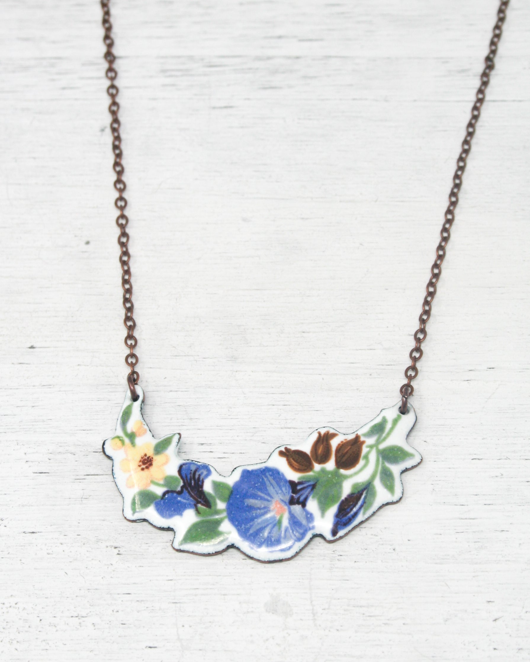 a necklace with a flower design on it