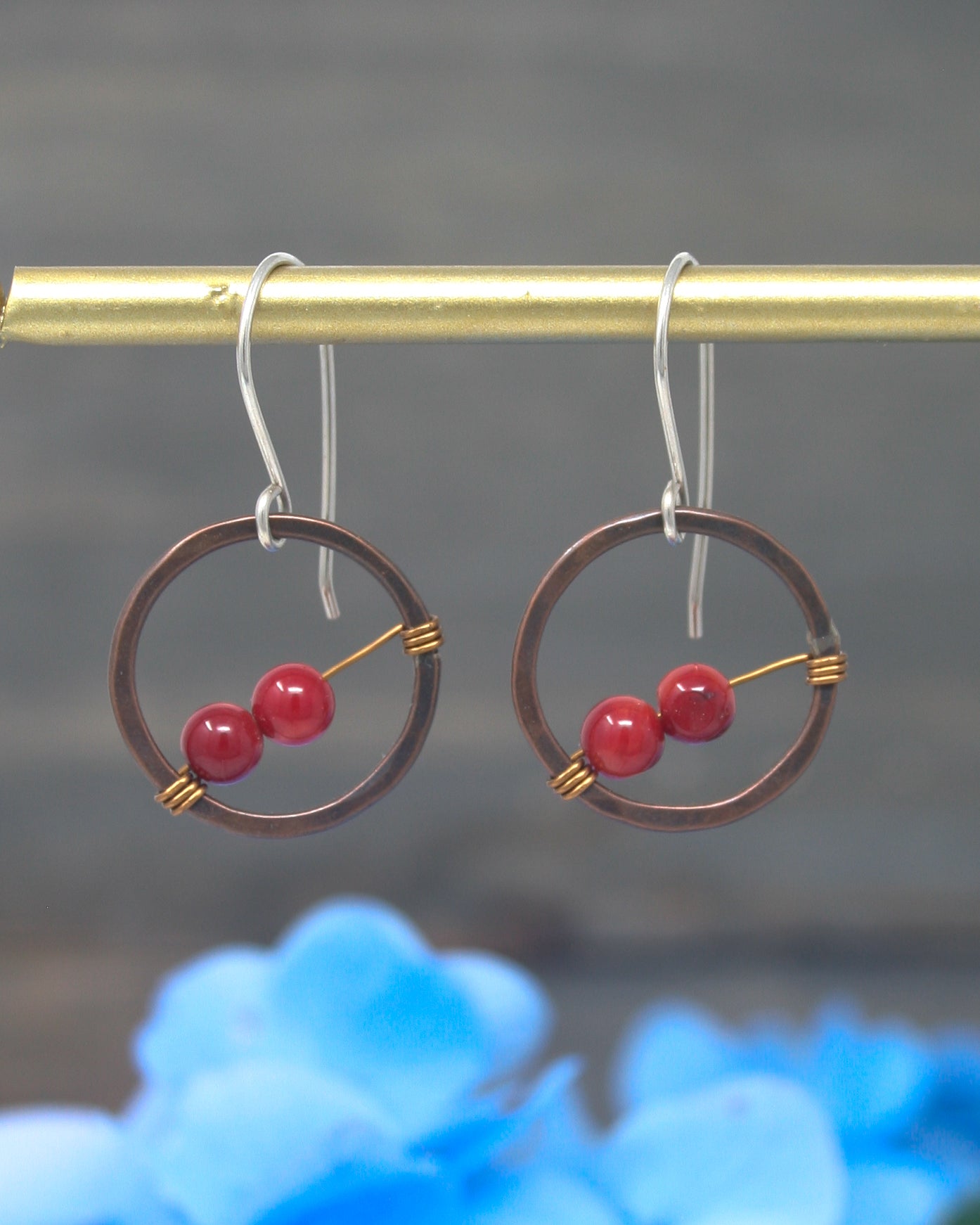 a pair of earrings hanging from a hook