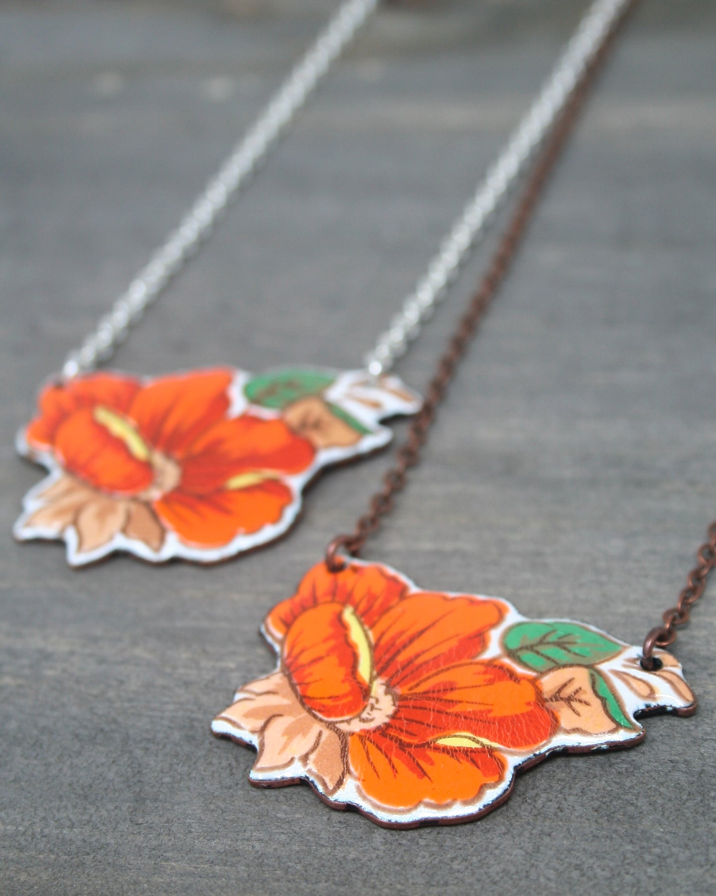 a couple of necklaces that have flowers on them