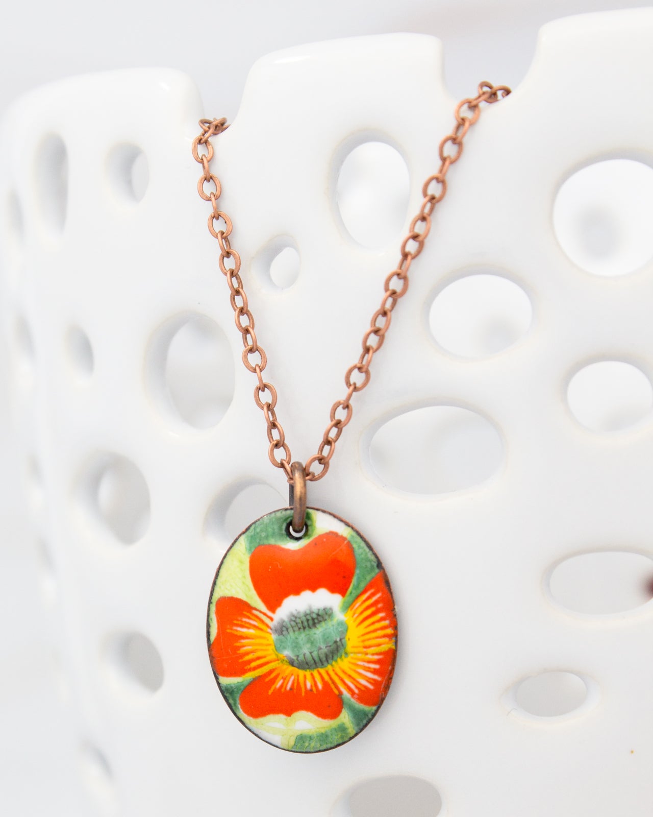A necklace with a pendant featuring a colorful flower design.
