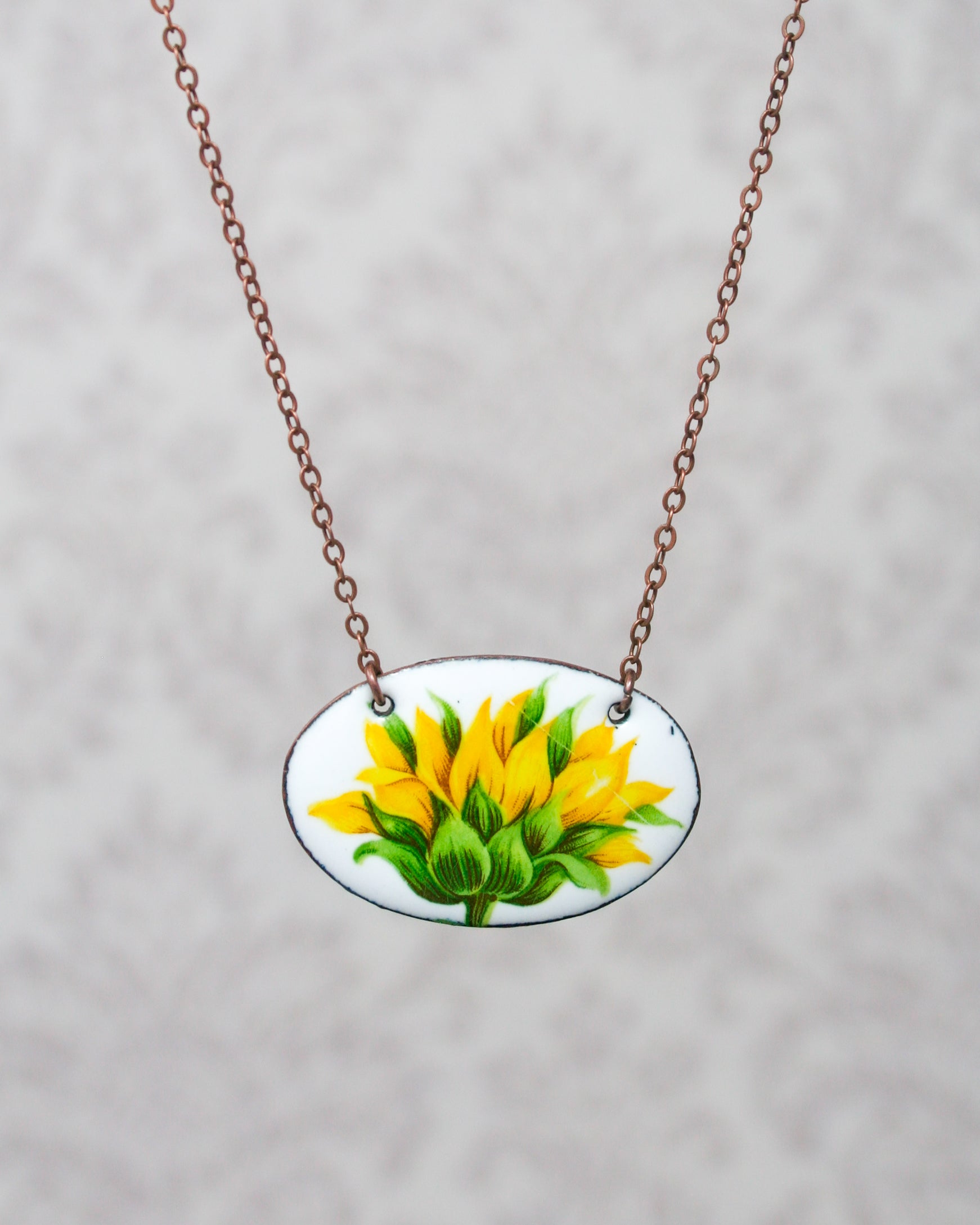 a necklace with a picture of a flower on it