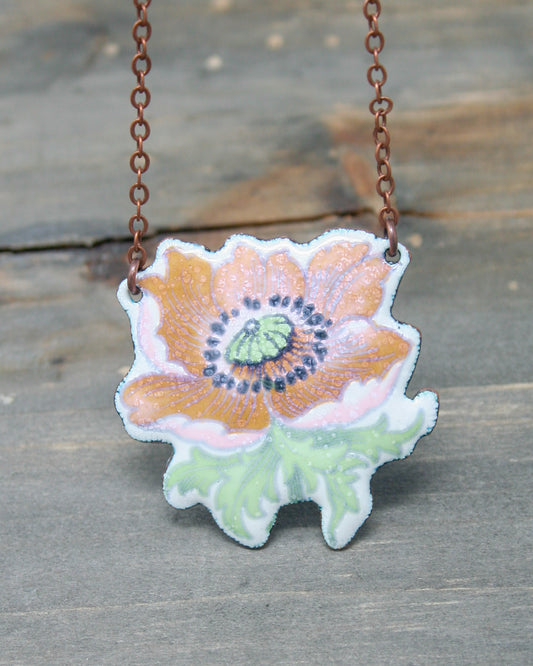 a necklace with a flower painted on it