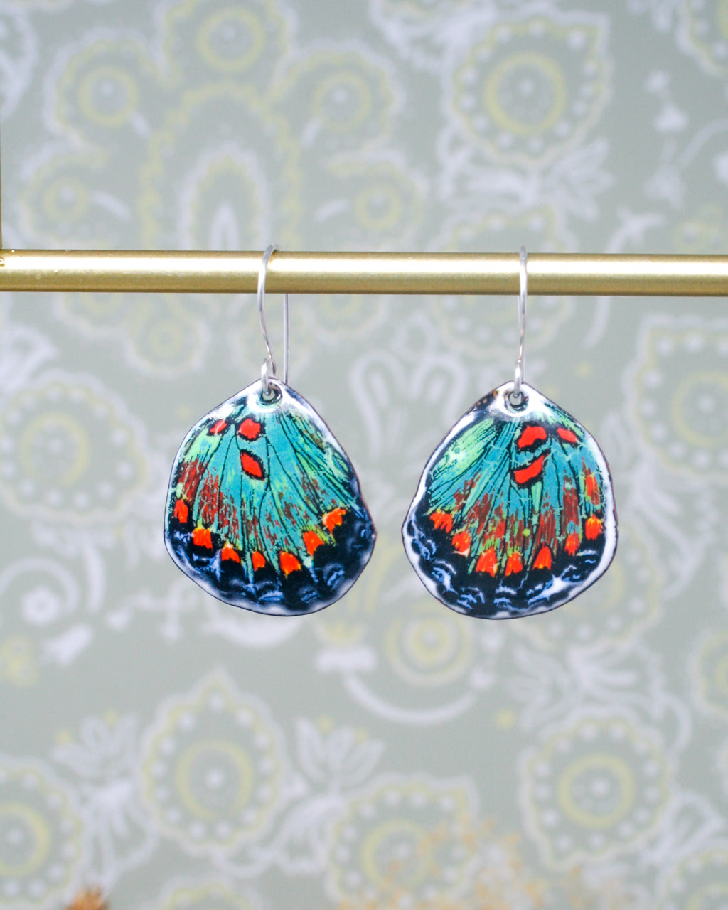 a pair of blue and orange butterfly earrings