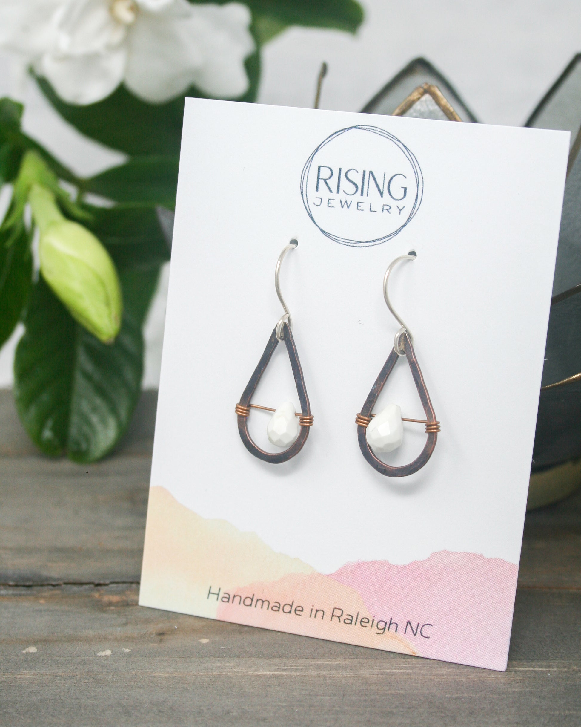 a card with a pair of earrings on it