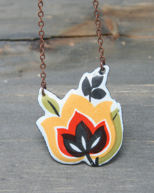 a necklace with a flower painted on it