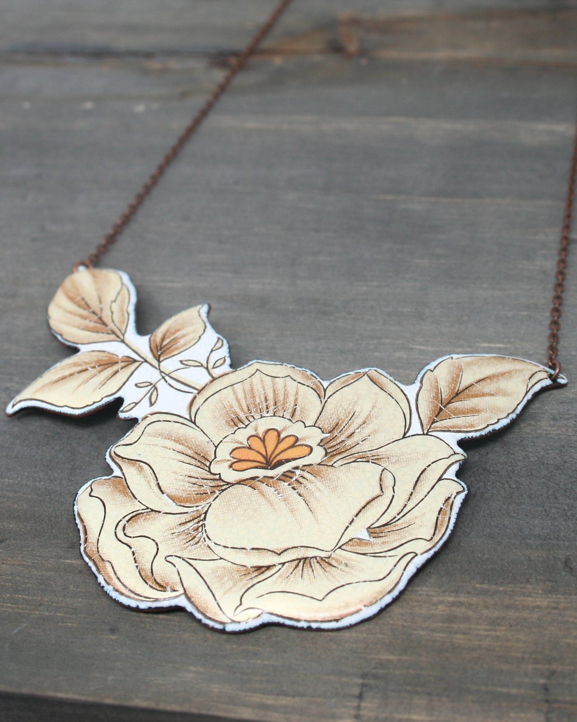 a necklace with a flower painted on it