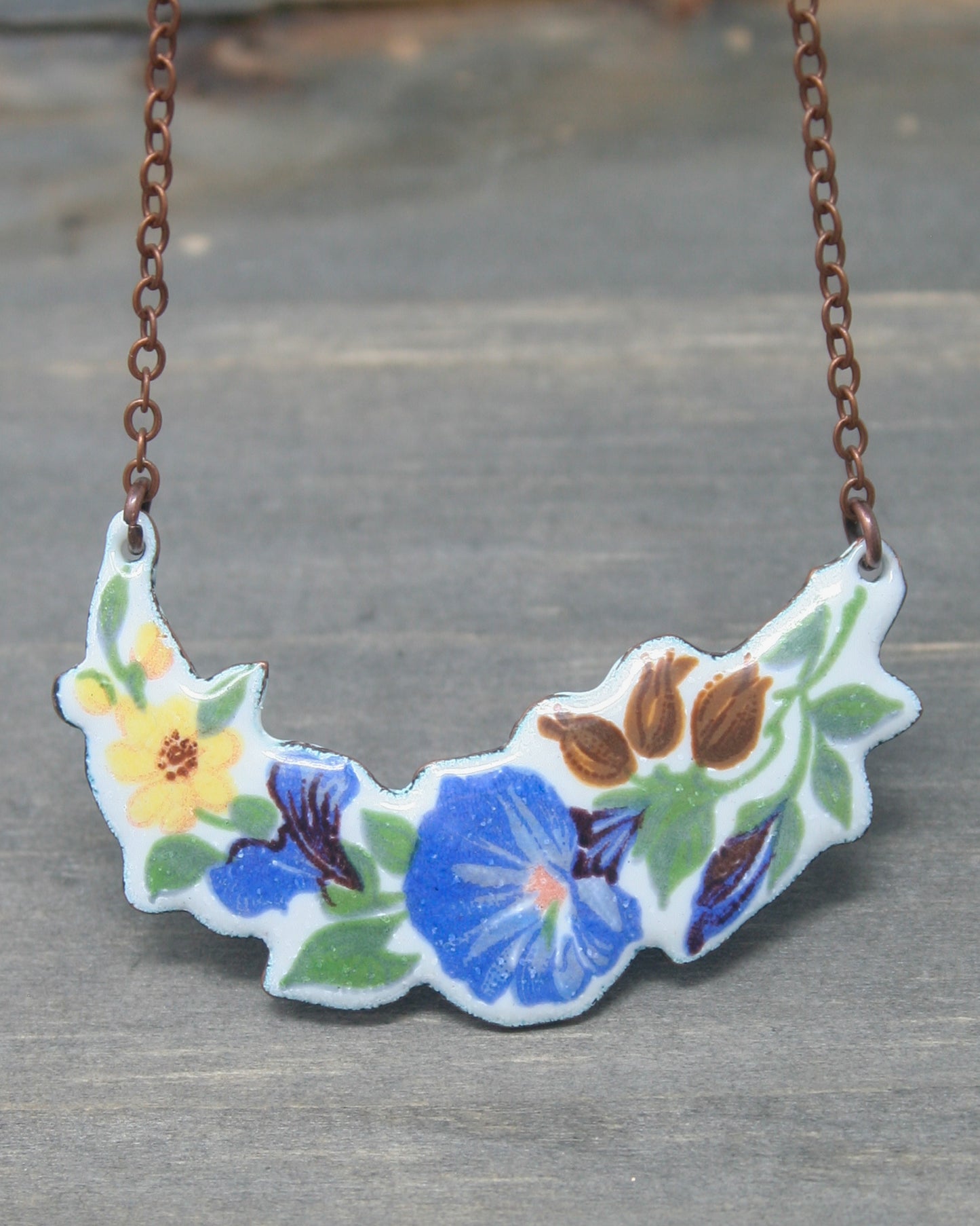 a necklace with a flower painted on it