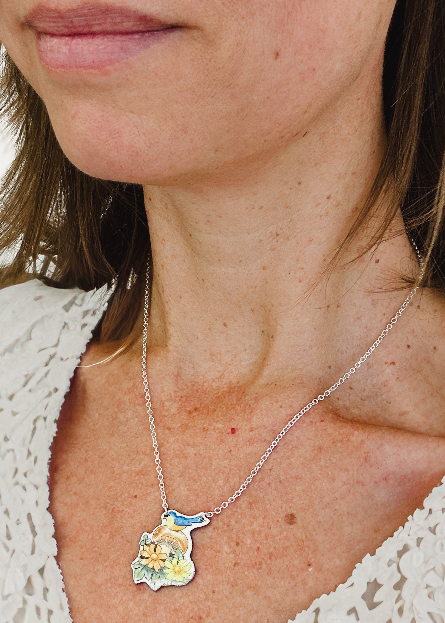 a close up of a woman wearing a necklace