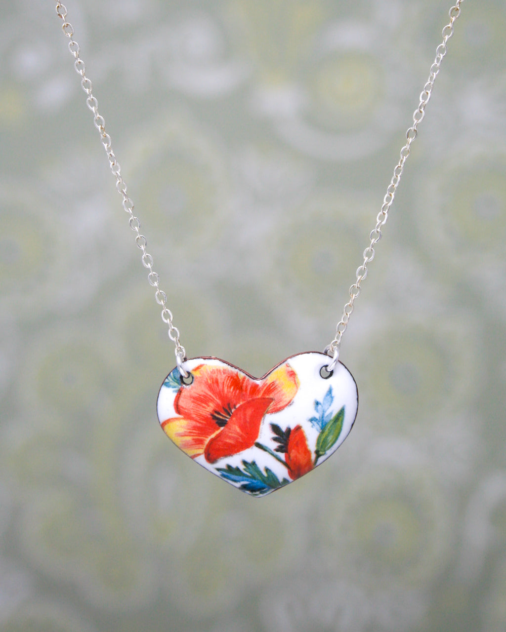 a necklace with a flower painted on it