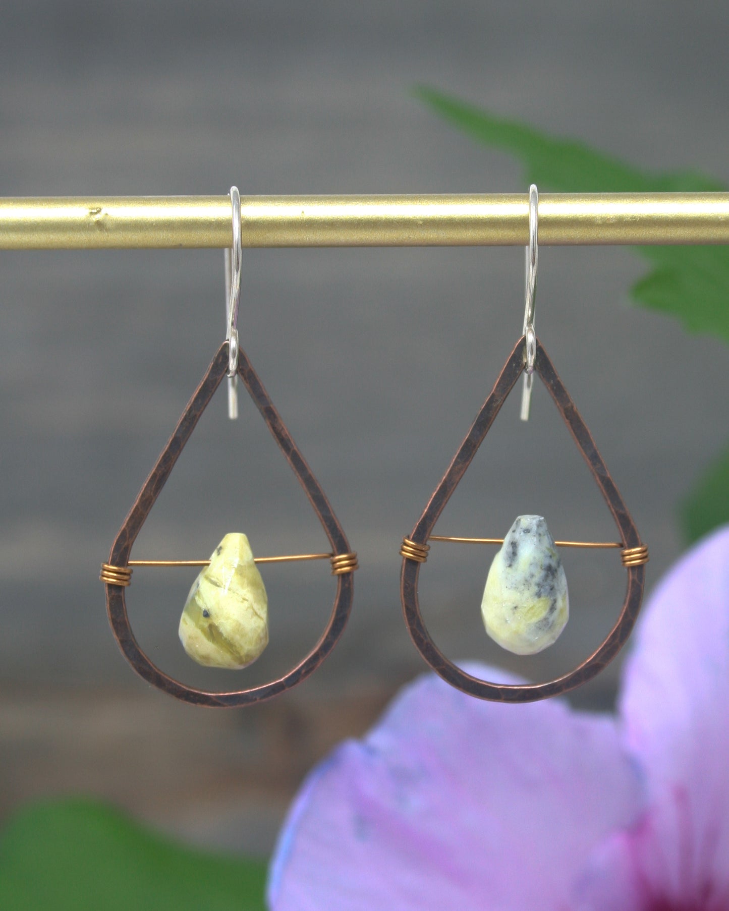 a pair of earrings hanging from a hook