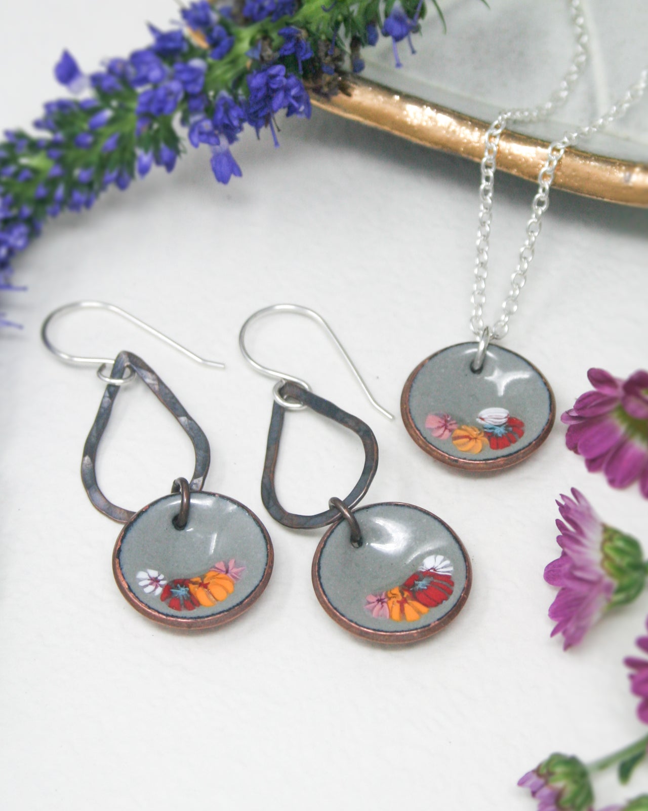a couple of necklaces and earrings on a table