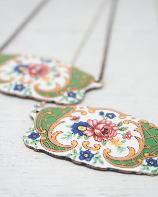 a couple of necklaces sitting on top of a table