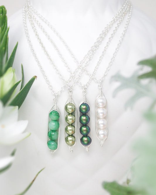 three necklaces with pearls and green beads
