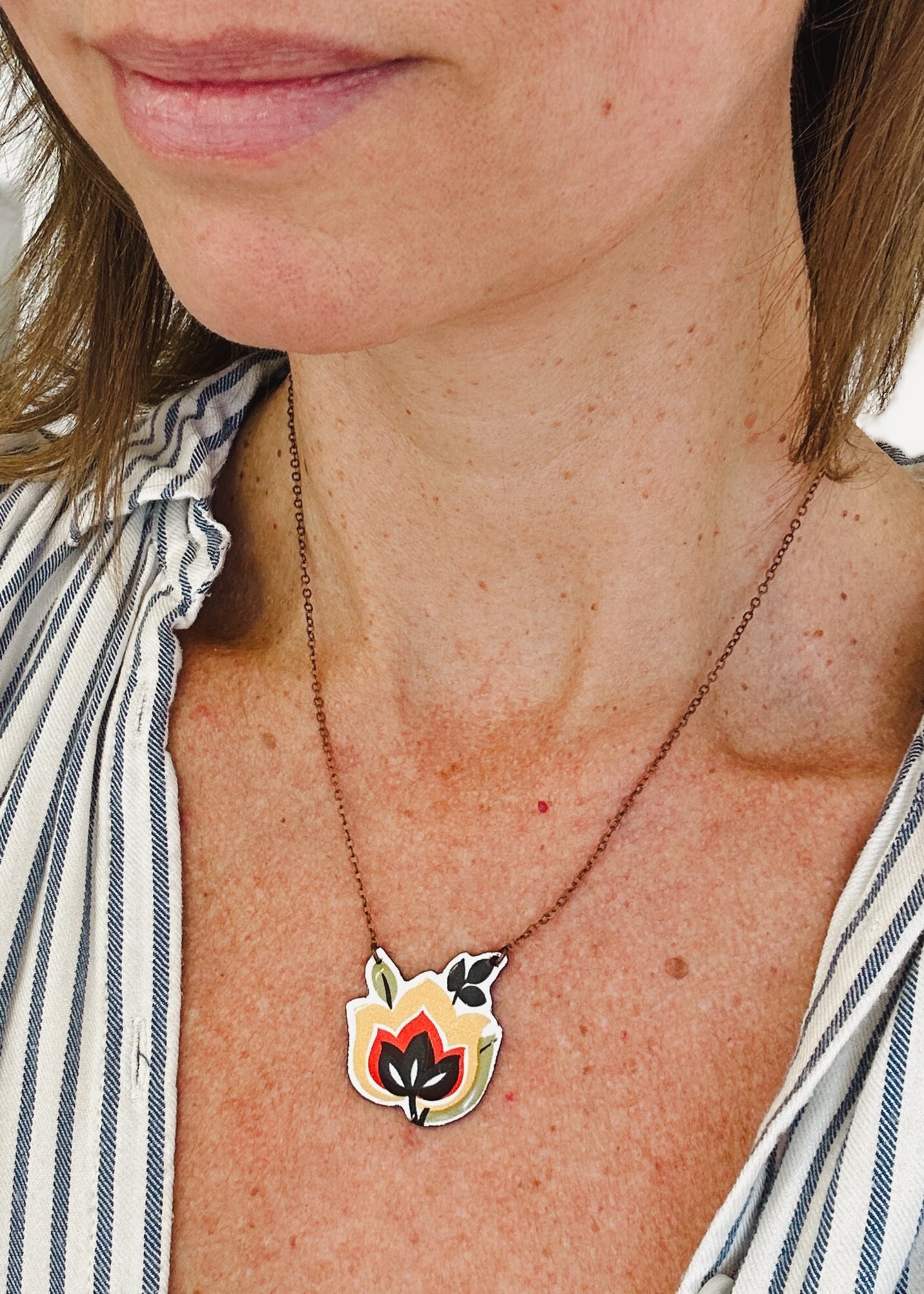 a close up of a woman wearing a necklace