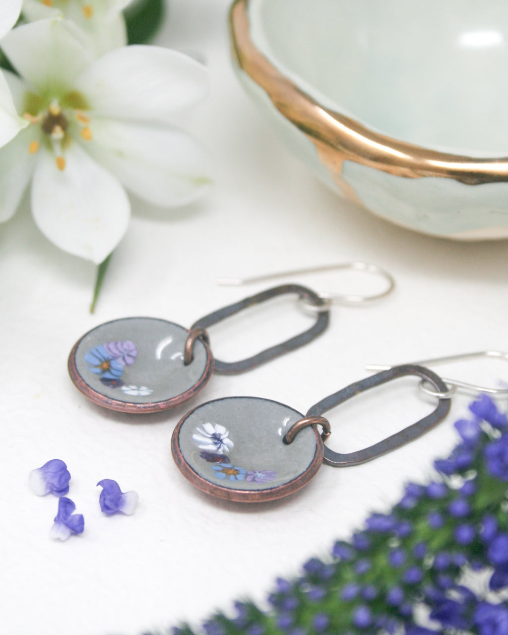 a pair of earrings sitting on top of a table