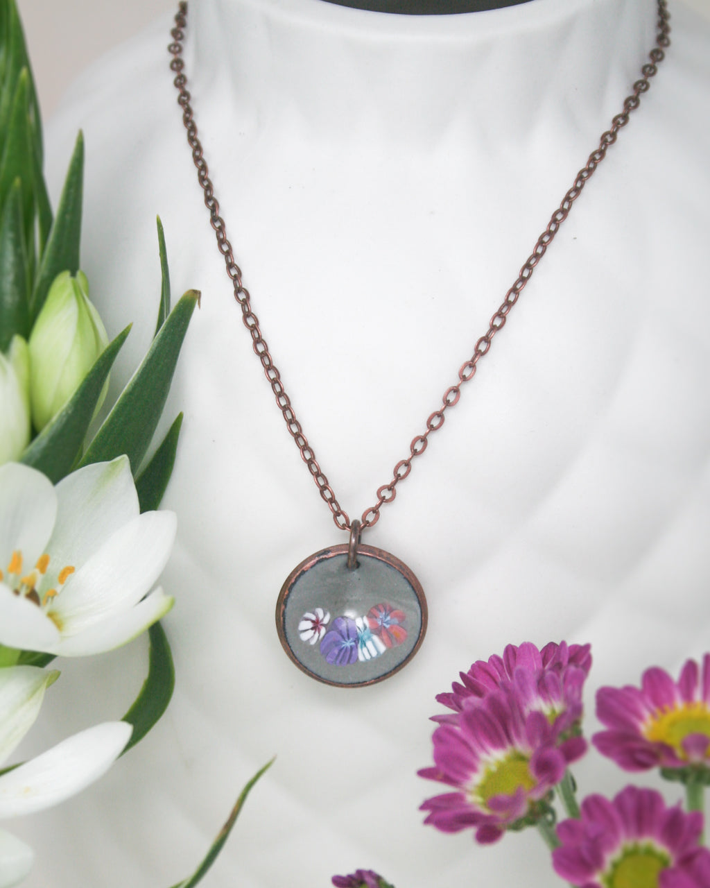 a necklace with a picture of a butterfly on it