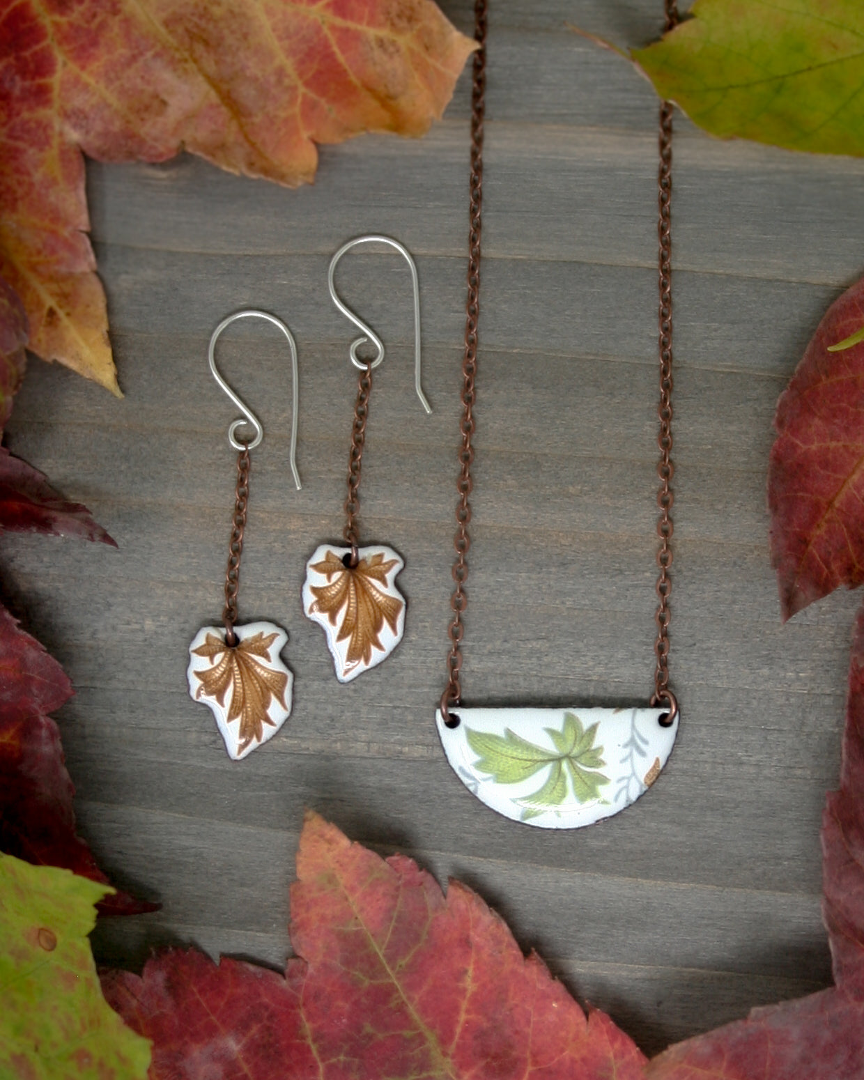 a couple of necklaces sitting on top of a wooden table