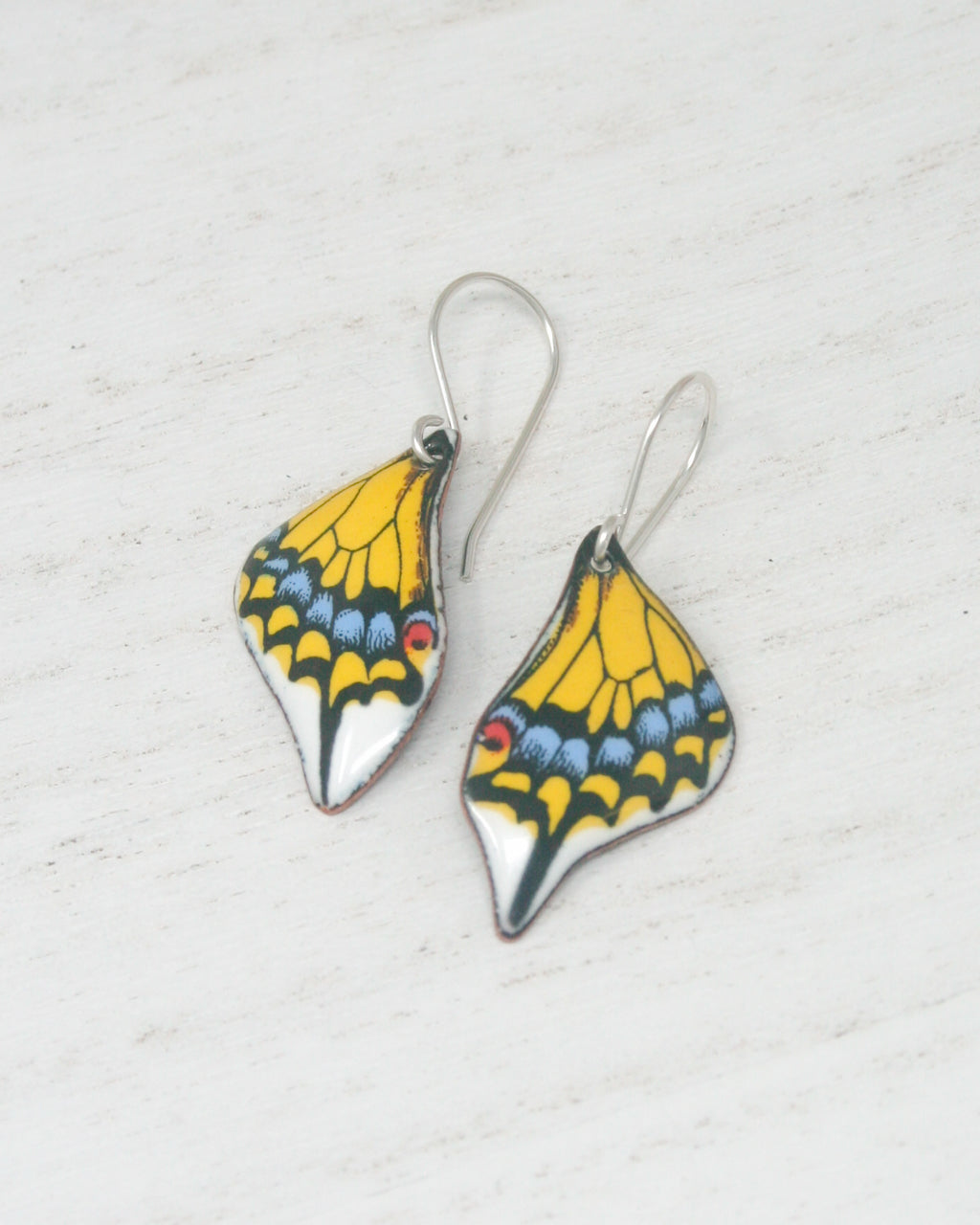 a pair of yellow and blue butterfly earrings