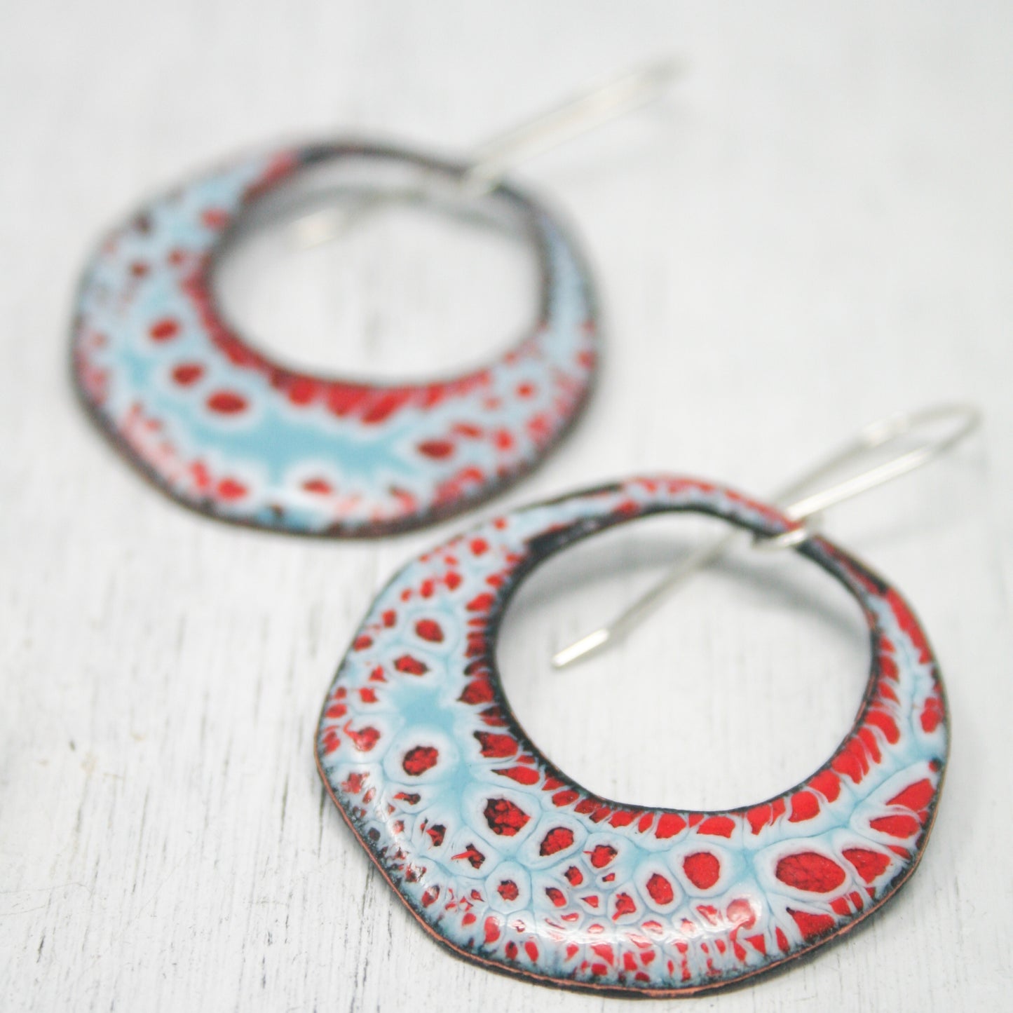 a pair of red, white and blue hoop earrings