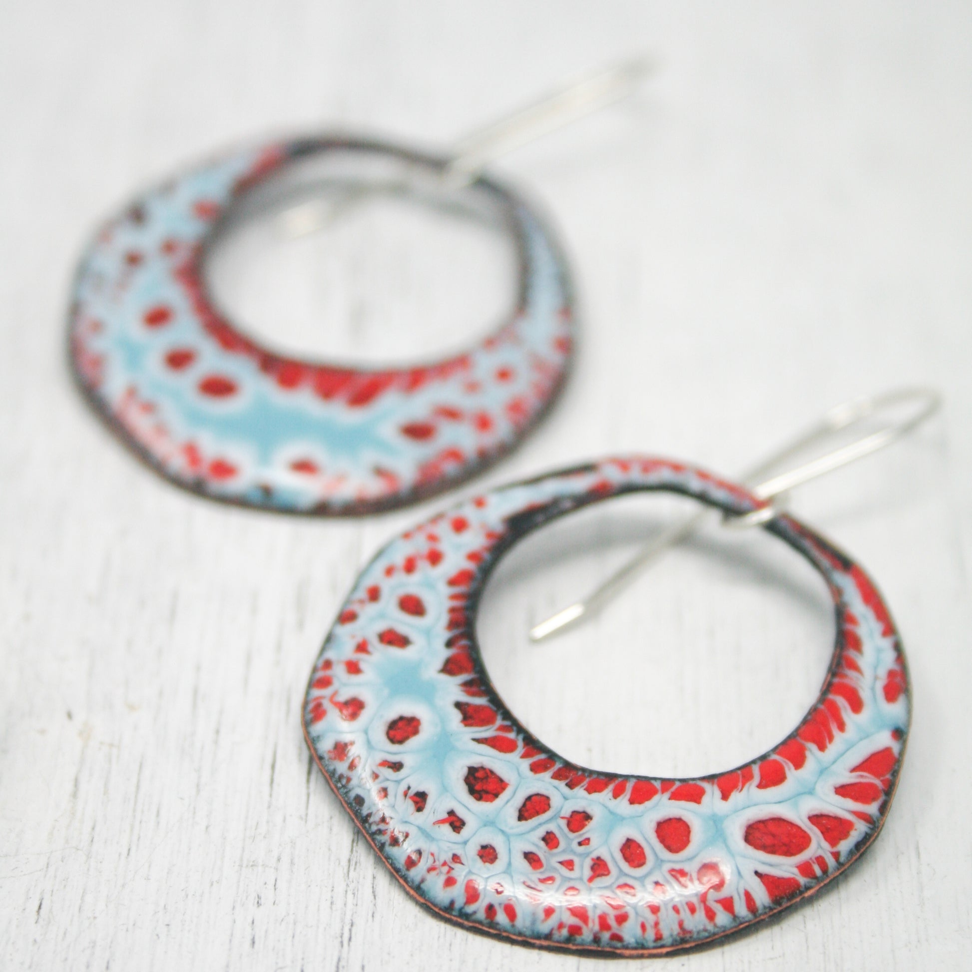 a pair of red, white and blue hoop earrings