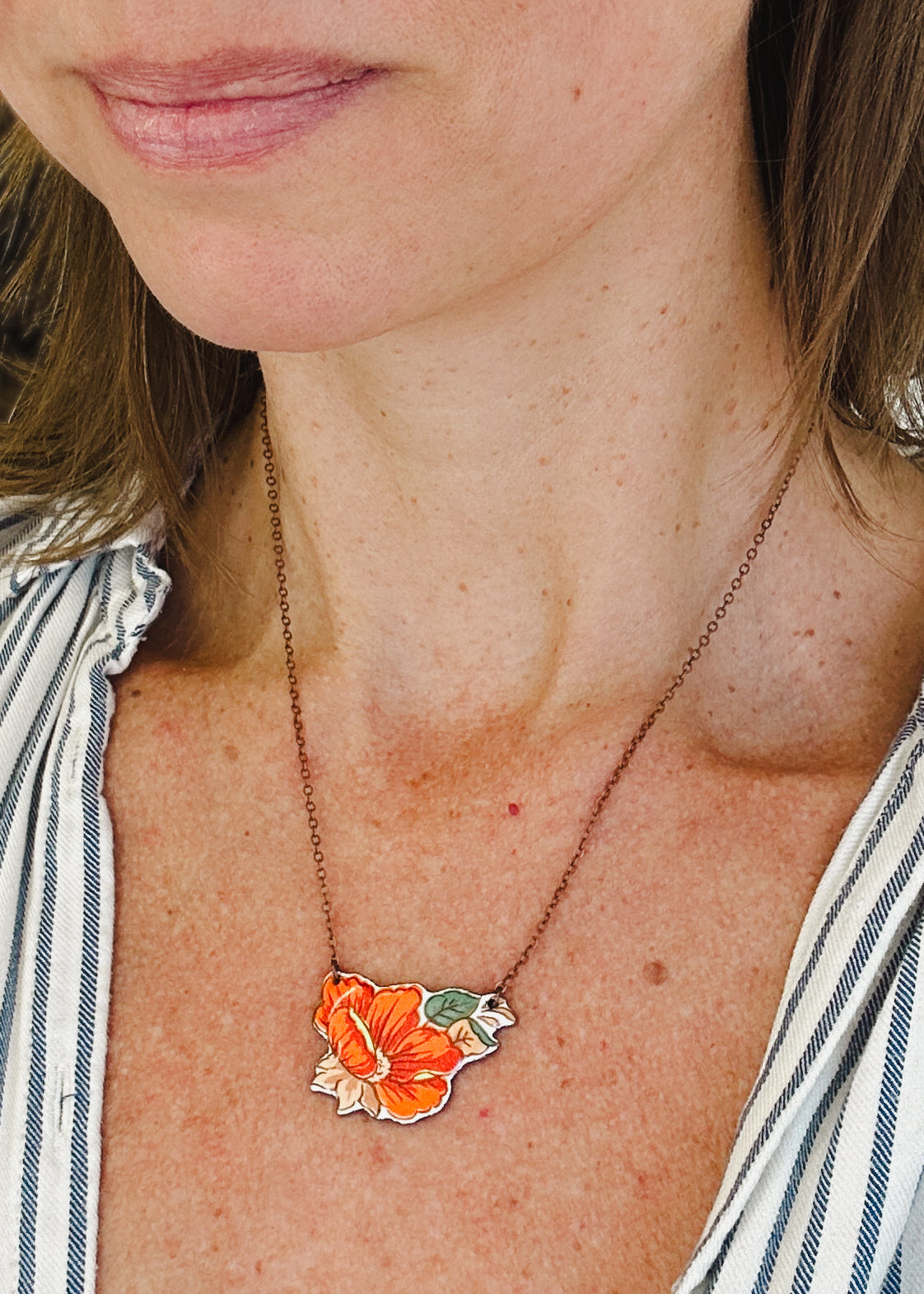 a close up of a woman wearing a necklace